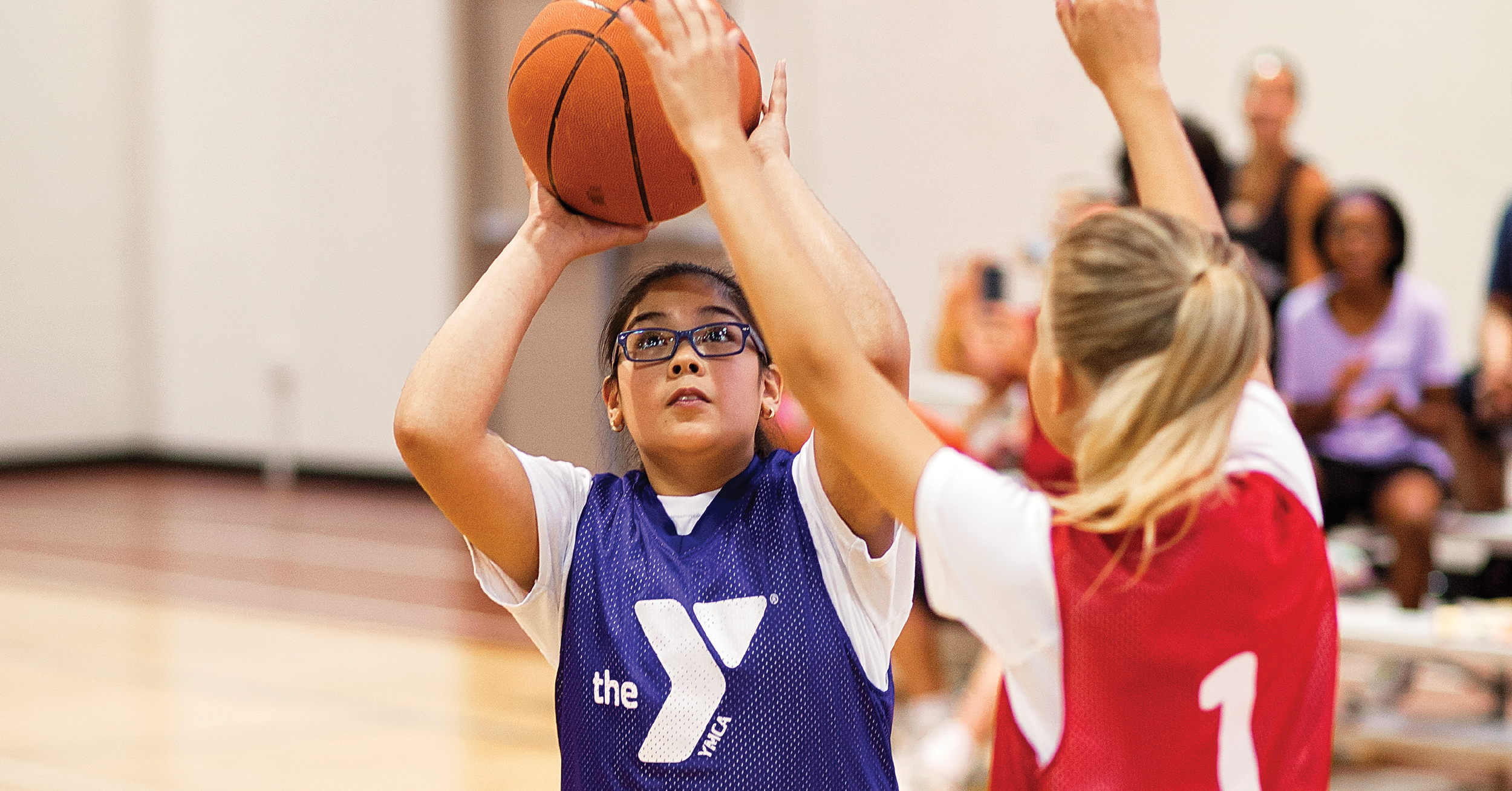 girl shooting basketball