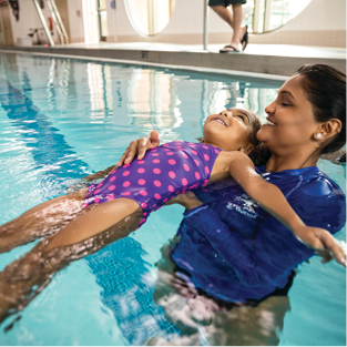 Y swim instructor teaching a girl to swim