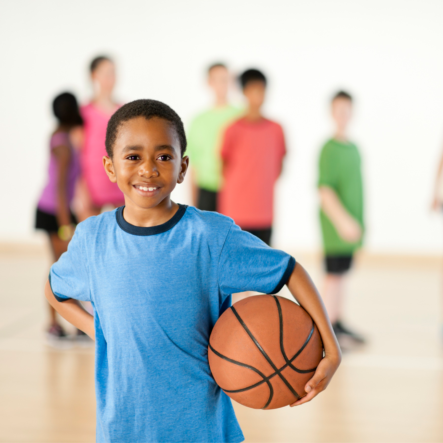 child holding a basketball