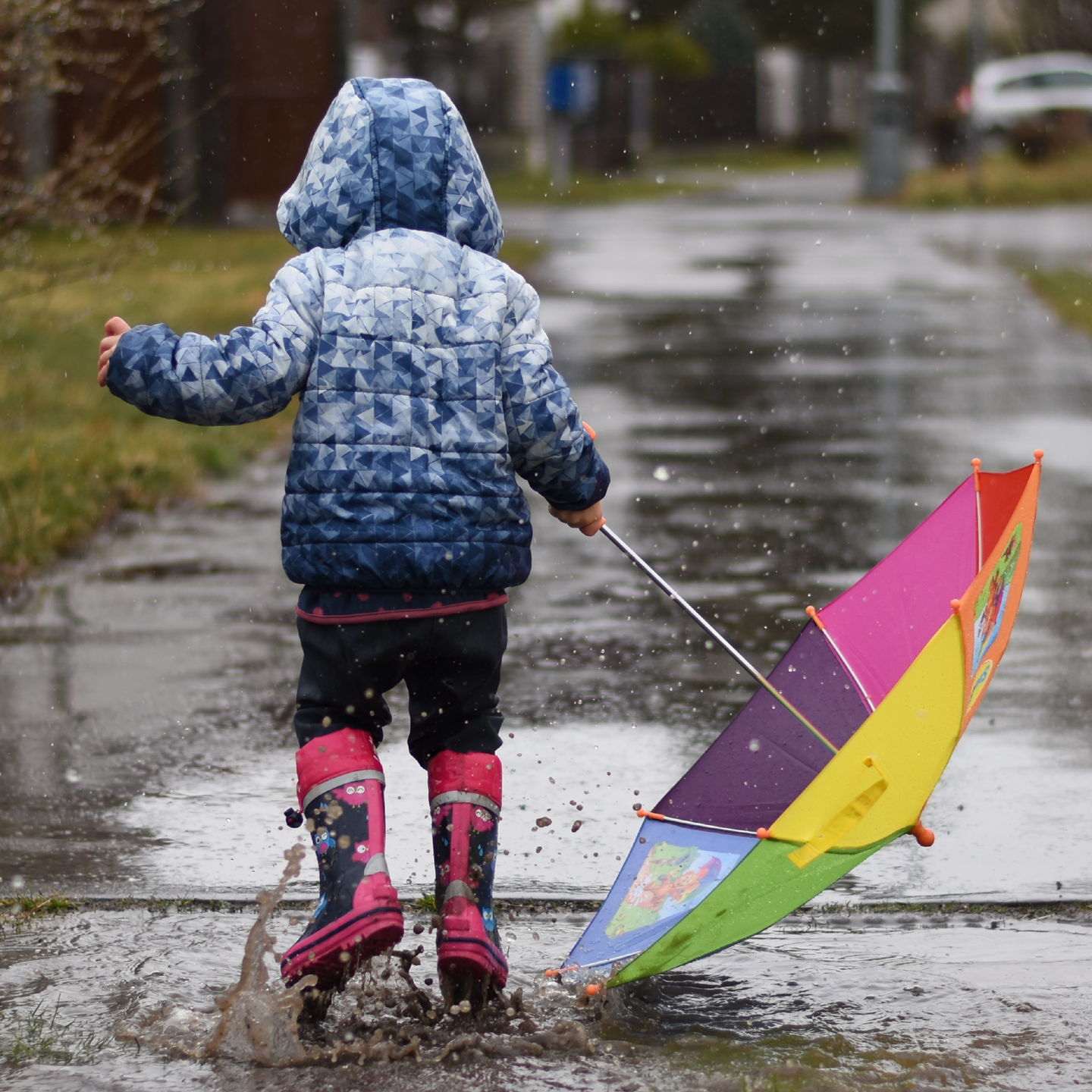 child playing in the rain