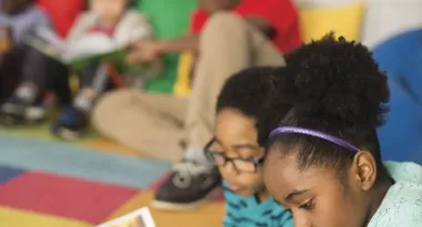 children reading books in a tutoring program