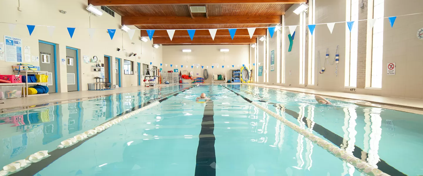 Three-lane indoor pool. Natural light from tall windows. 