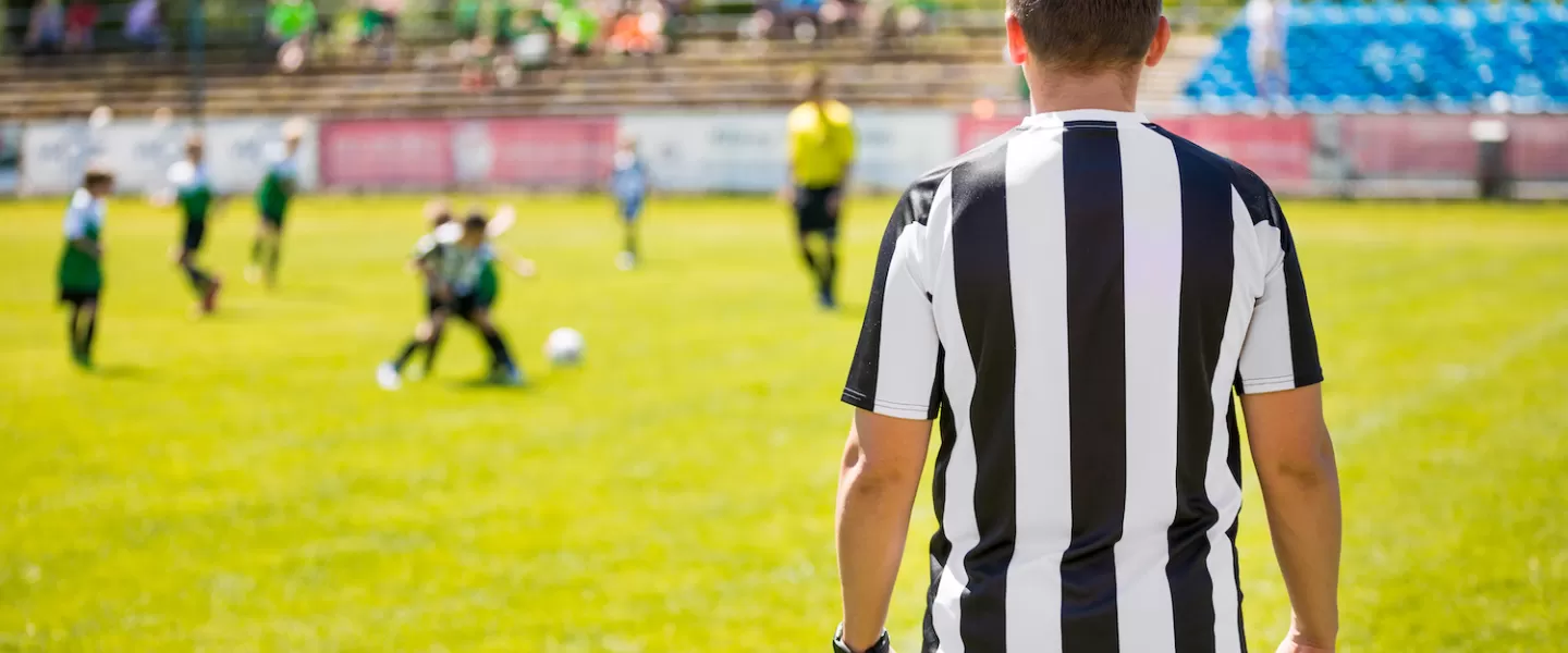 YMCA Youth Sports Official Refereeing a Youth Soccer Game