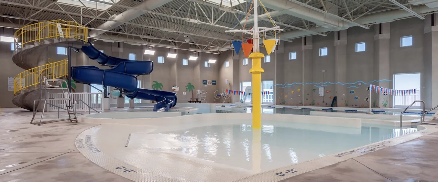 Ste Genevieve County YMCA Community Center Indoor Aquatic Center with zero-depth entry pool, waterslide, splash pad, and lap lanes