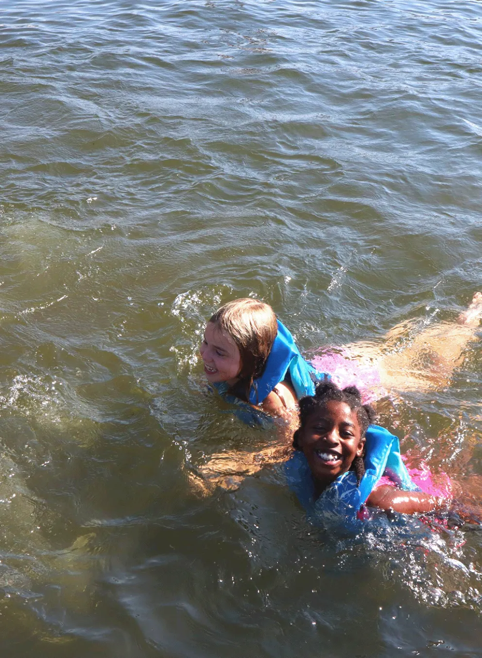 Two friends swimming in YMCA Camp Lakewood's private lake, Sunnen Lake, in Potosi, MO