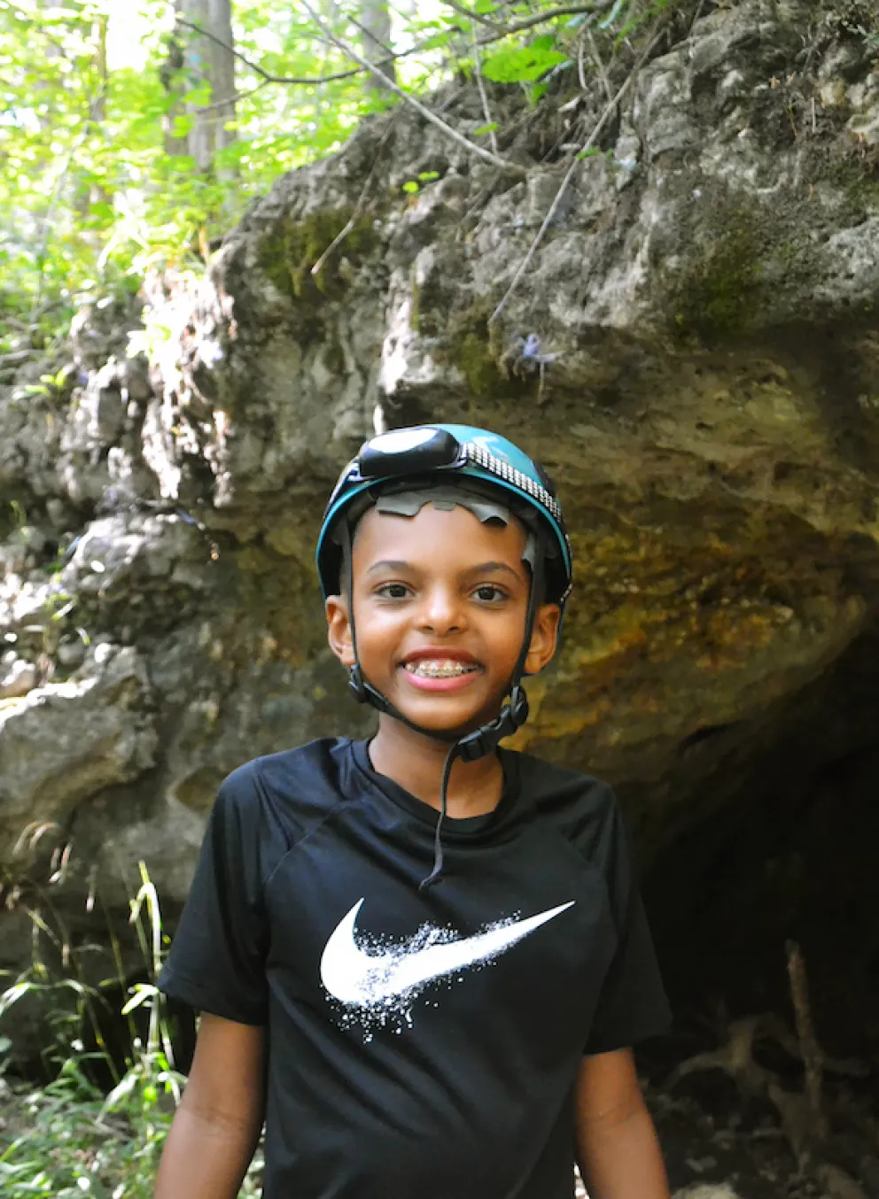 YMCA Camp Lakewood Camper wearing a helmet on a cave excursion