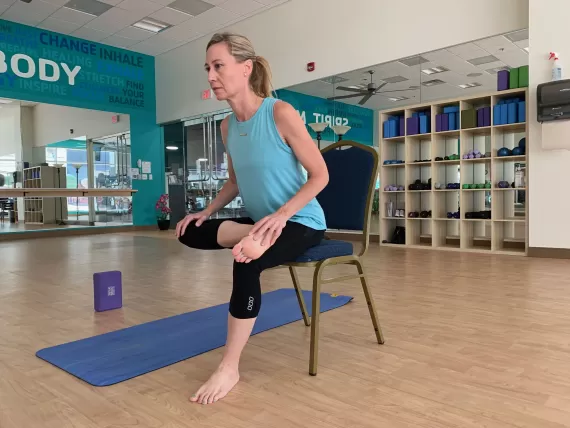 woman doing seated pigeon pose