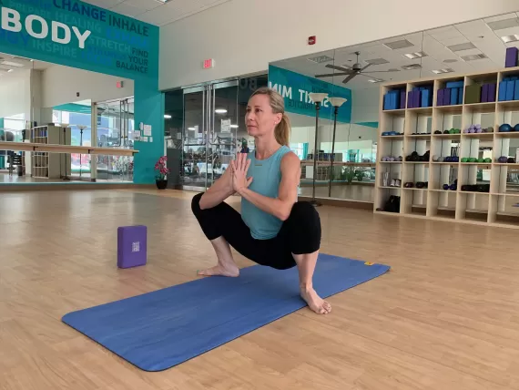 woman doing a squat pose in yoga