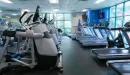 Thumbnail: Cardio room with rows of treadmills, ellipticals, and stationary bikes. Windows on all sides of room.