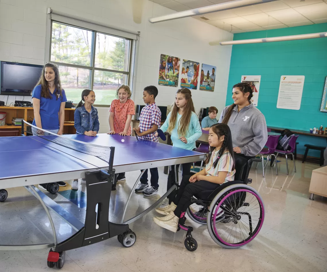 Gateway Region YMCA Y Club: Before and After School Program Staff and Students playing Ping-Pong