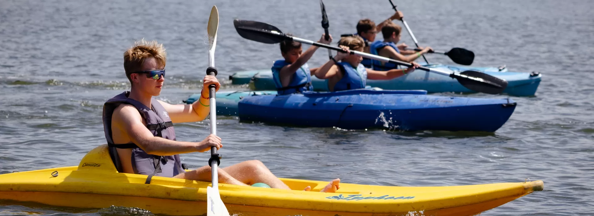Boys paddleboarding and kayaking