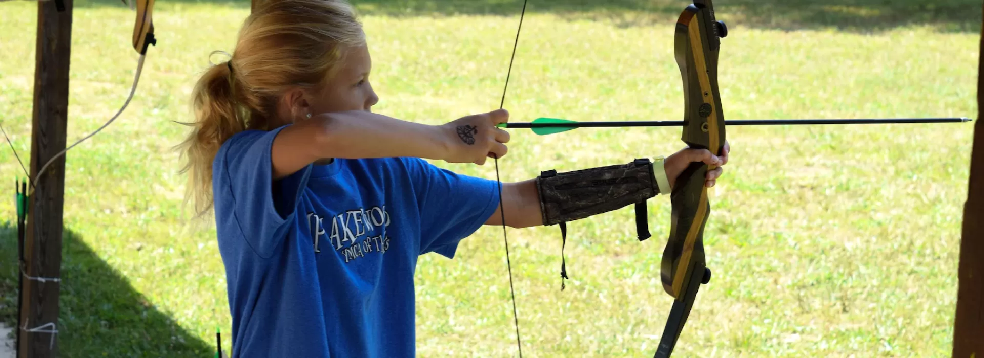 ymca camp lakewood archery bow and arrow drawn at target
